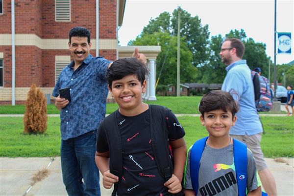 Students walking in on the first day of school. 